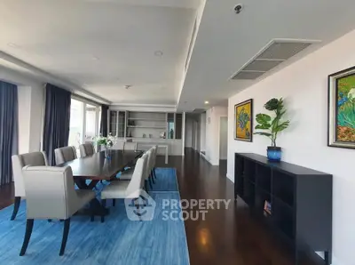 Spacious dining room with elegant decor and large windows in modern apartment