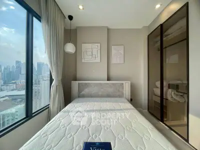 Modern bedroom with city view and stylish decor in high-rise apartment.