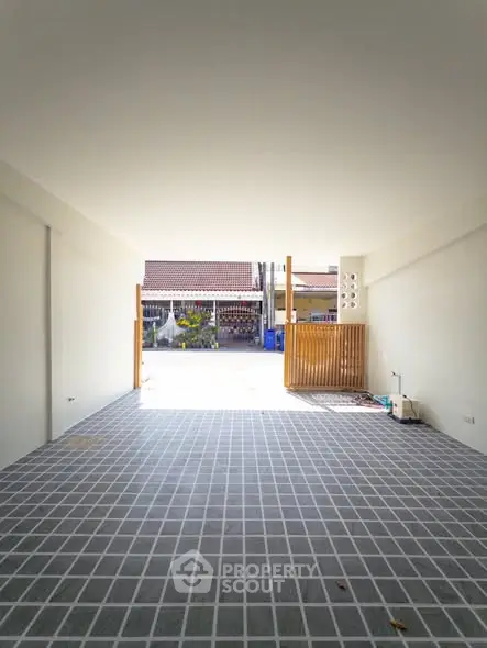 Spacious open garage with tiled flooring and natural light
