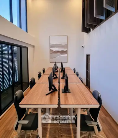 Modern study room with sleek desks and computers, ideal for collaborative work in a stylish setting.