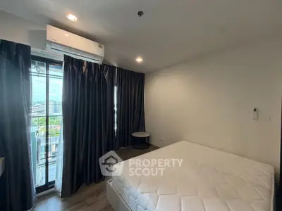 Modern bedroom with large window and air conditioning, offering a cozy and comfortable living space.