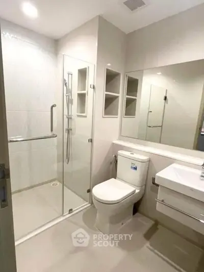 Modern bathroom with glass shower and sleek fixtures