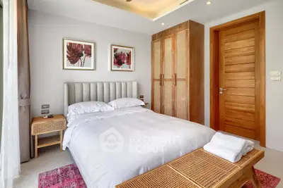Elegant bedroom with modern decor, featuring a cozy bed, stylish wooden furniture, and soft lighting.