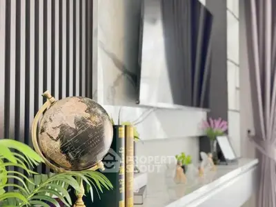 Elegant living room with modern decor and stylish globe on marble shelf.