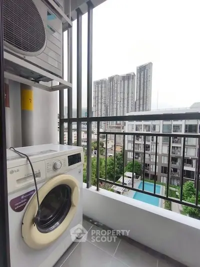Modern balcony with washing machine and city view, perfect for urban living.