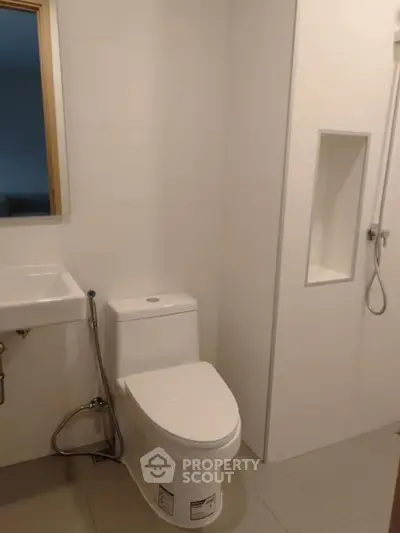 Modern minimalist bathroom with sleek fixtures and neutral tones.