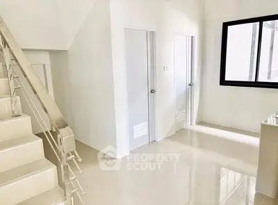 Bright modern interior with sleek staircase and glossy floors