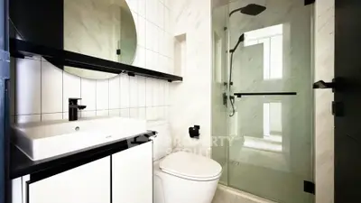Modern bathroom with sleek fixtures and glass shower enclosure