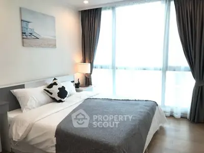 Bright and cozy bedroom with modern decor and large window