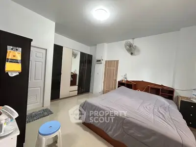 Spacious bedroom with modern furnishings and ample storage space