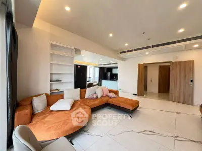 Spacious modern living room with stylish orange sectional sofa and open kitchen layout.