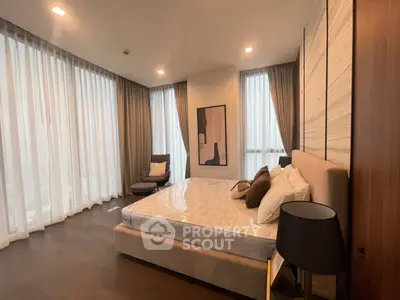 Luxurious bedroom with elegant decor and floor-to-ceiling windows
