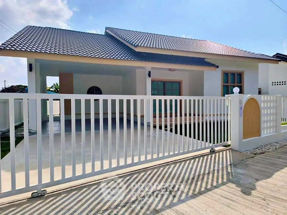 Charming single-story home with modern design and spacious driveway, perfect for family living.