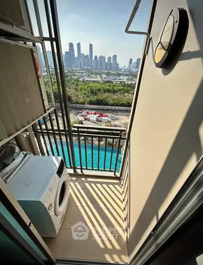 Charming balcony with city skyline view and washing machine, perfect for urban living.