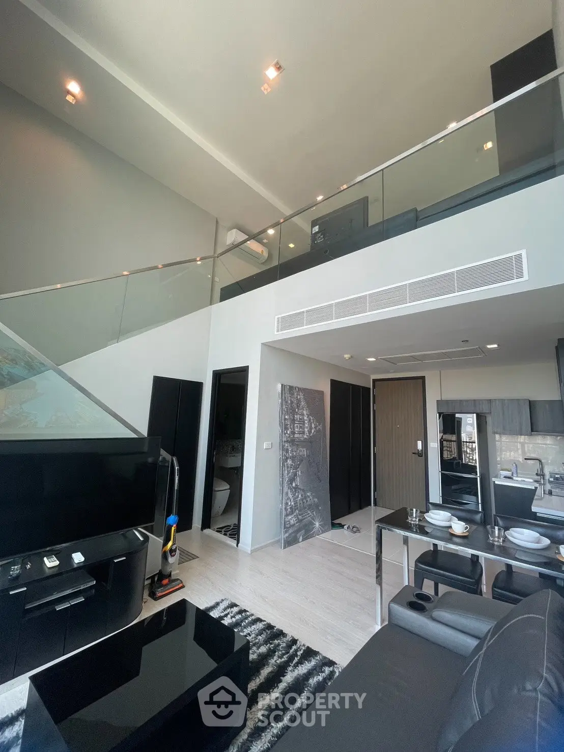 Modern duplex apartment with open living area and stylish kitchen
