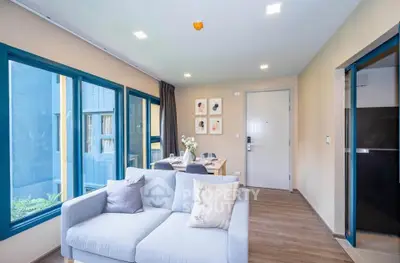 Modern living room with stylish decor and large windows in a contemporary apartment.