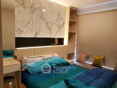 Modern bedroom with stylish marble accents and cozy bedding