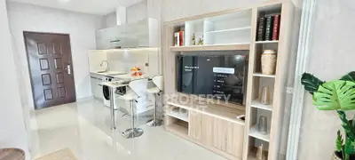 Modern open-plan kitchen and living area with sleek design and stylish furnishings.
