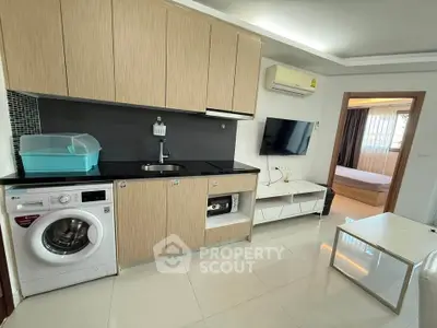 Modern compact kitchen with washing machine and sleek cabinetry