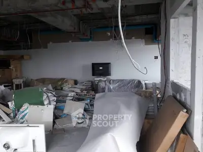 Under-construction interior with exposed wiring and building materials