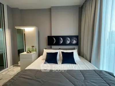 Modern bedroom with stylish decor and moon phase artwork above bed