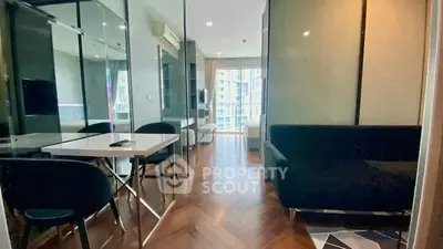 Modern apartment interior with sleek design and city view, featuring a cozy living area and stylish dining space.