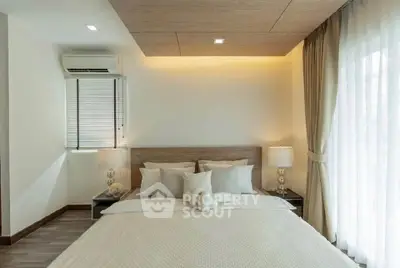 Elegant bedroom with modern decor and natural light