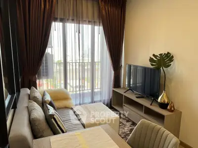 Modern living room with cozy sofa, TV, and balcony view