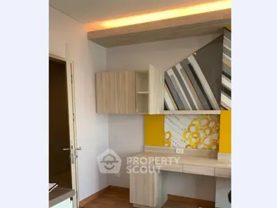 Modern study room with stylish wooden cabinetry and geometric wall art