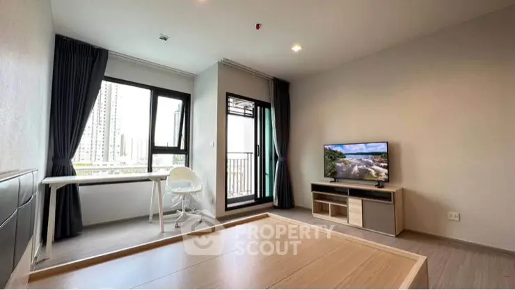 Modern living room with large window and balcony view in high-rise apartment.