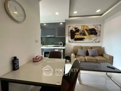 Modern living room with sleek kitchen and stylish decor