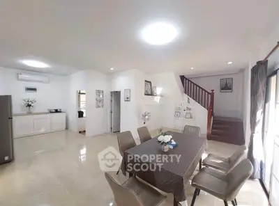 Spacious open-plan living and dining area with modern decor and natural light