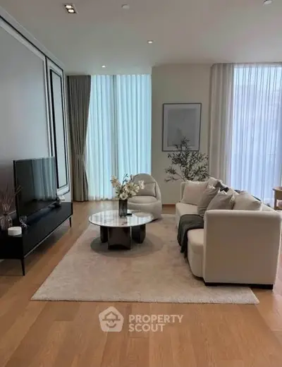 Elegant modern living room with stylish furniture and large windows