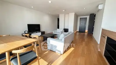 Spacious modern living room with wooden flooring and stylish furniture