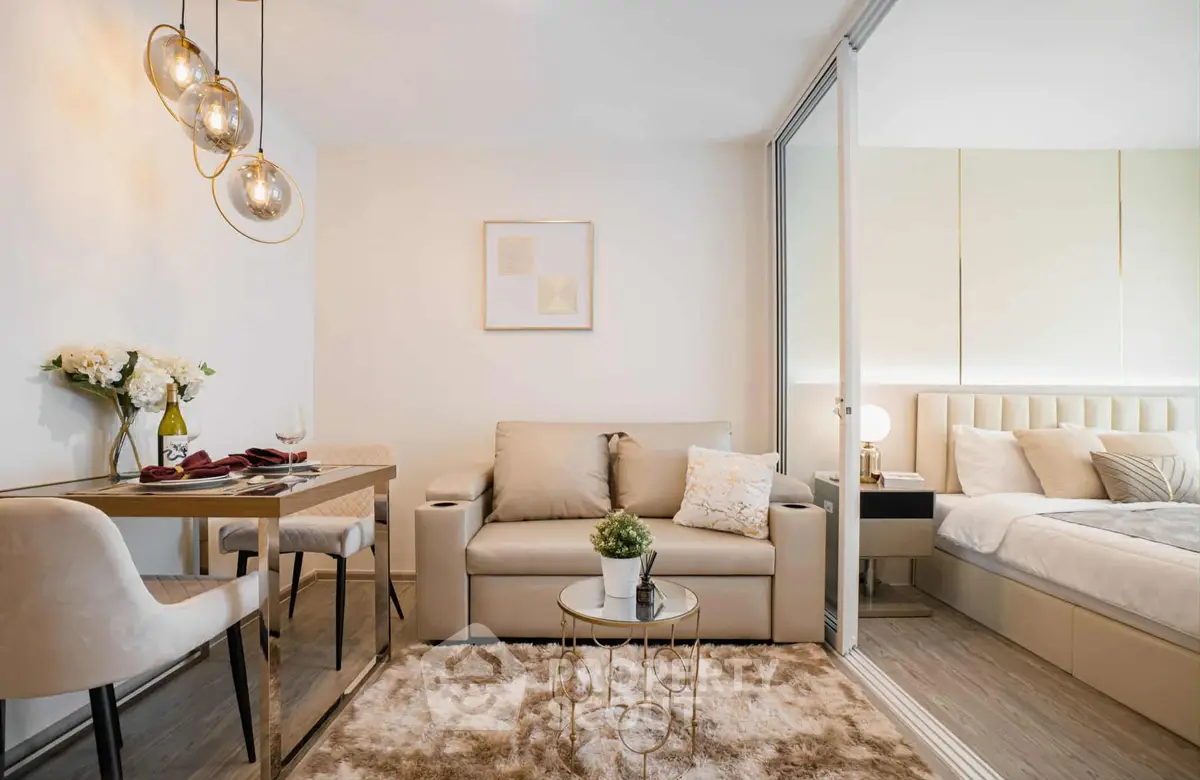 Modern studio apartment with cozy living area and elegant bedroom, featuring stylish decor and ambient lighting.