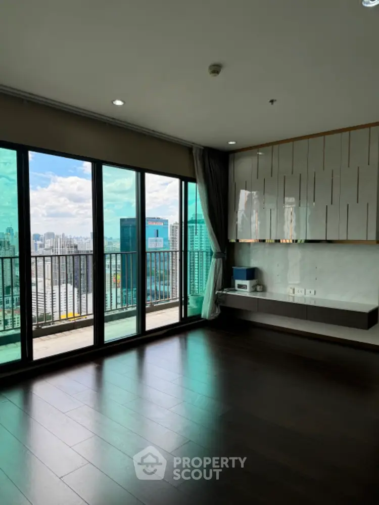 Spacious modern living room with city view and large balcony access