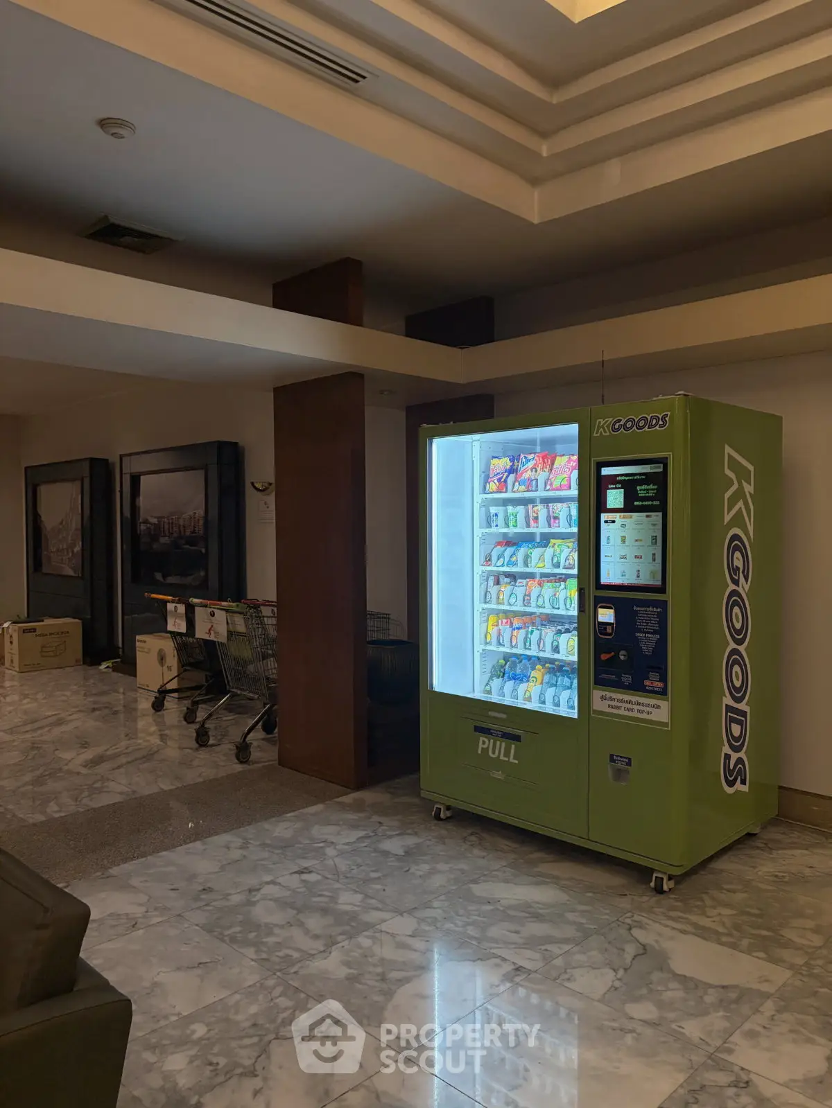 Modern lobby with vending machine and marble flooring in upscale building