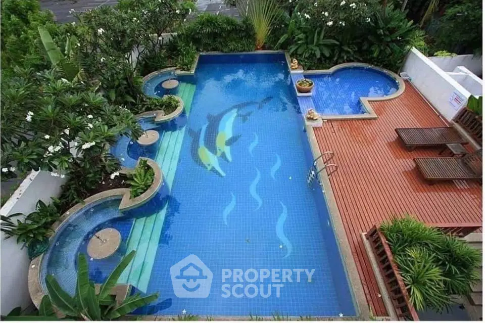 Luxurious outdoor pool with unique design and lush greenery