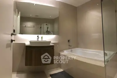 Modern bathroom with sleek design and bathtub in a contemporary apartment.