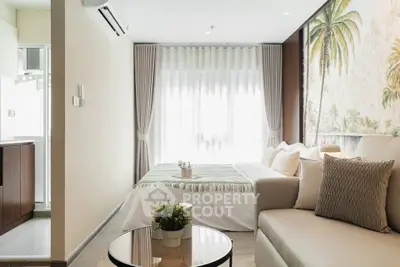 Modern living room with cozy sofa, elegant decor, and large window for natural light.