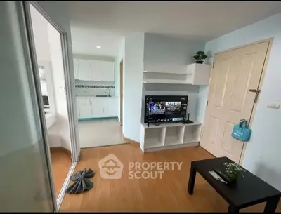 Cozy living room with TV and modern decor in a compact apartment