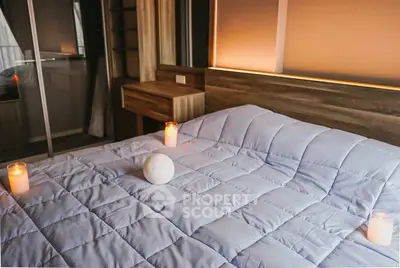 Cozy bedroom with soft lighting and candles for a relaxing ambiance.