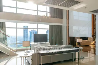 Luxurious high-rise living room with panoramic city views and elegant modern decor.