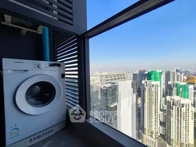 High-rise city view with washing machine on balcony, perfect urban living.
