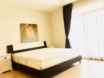 Spacious bedroom with large window and modern decor