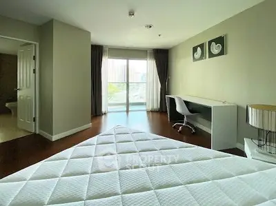 Spacious bedroom with modern decor and city view from large window