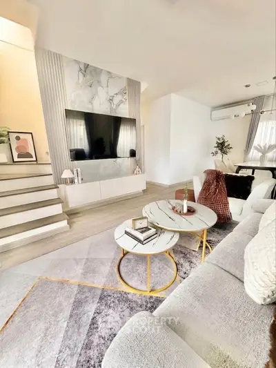 Luxurious modern living room with stylish decor and elegant marble TV wall