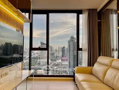 Luxurious living room with stunning city skyline view through large windows, featuring elegant decor and cozy seating.