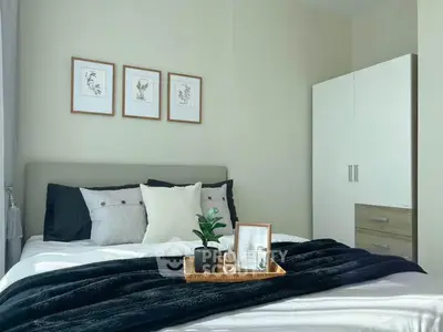 Cozy bedroom with stylish decor and modern wardrobe, perfect for relaxation and comfort.