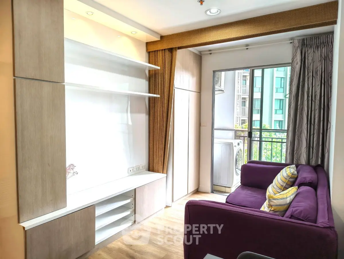 Bright living room with purple sofa and balcony access in modern apartment